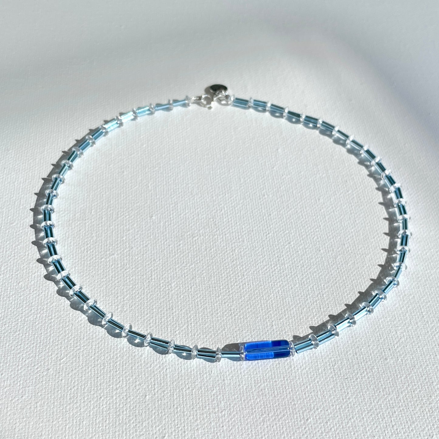 Bluejazz Necklace – vibrant glass beads and silver details catching light for a refined, modern look.