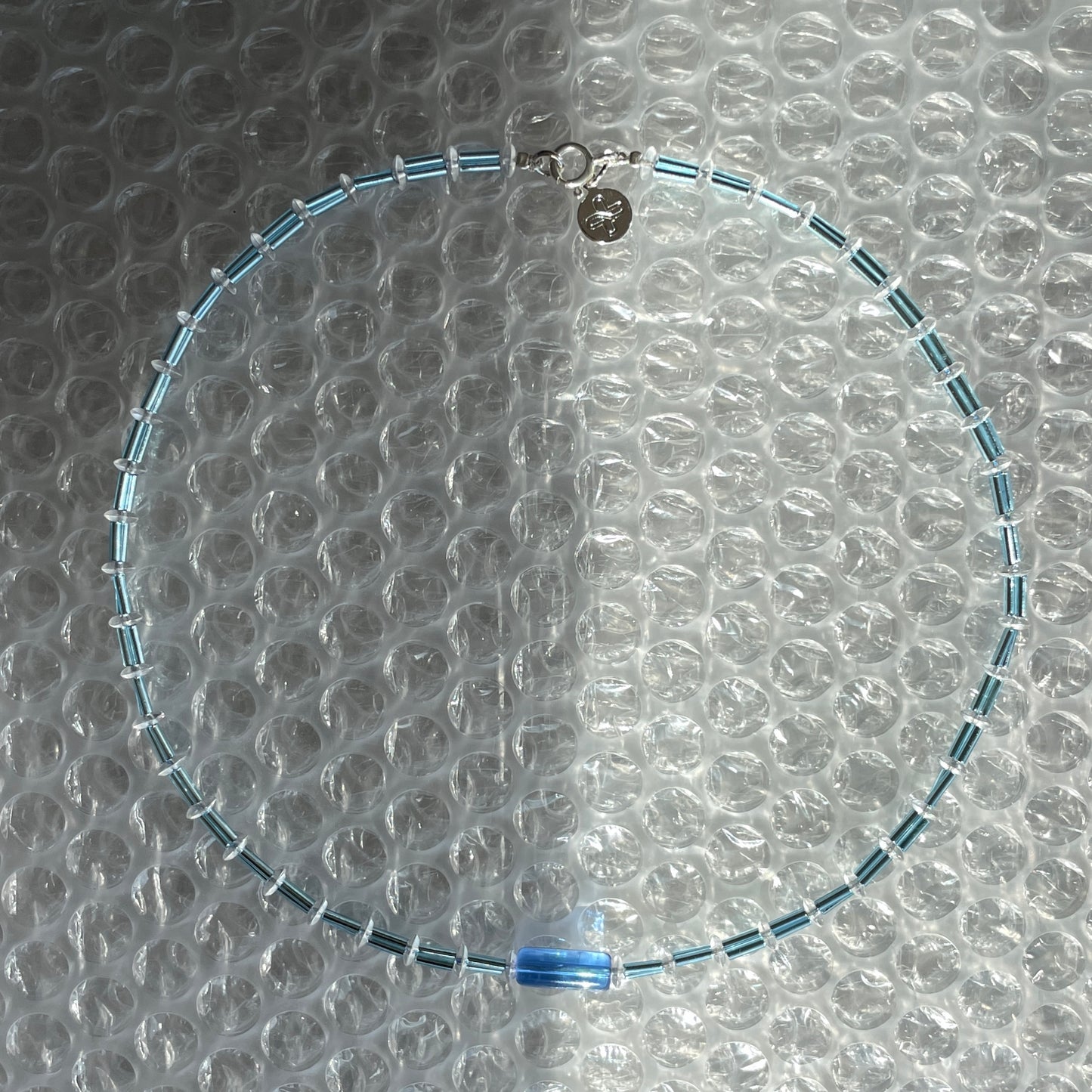 Detail of Bluejazz Necklace showing premium glass beads in deep blue and jewel tones with 925 sterling silver clasp, handmade in Cyprus.