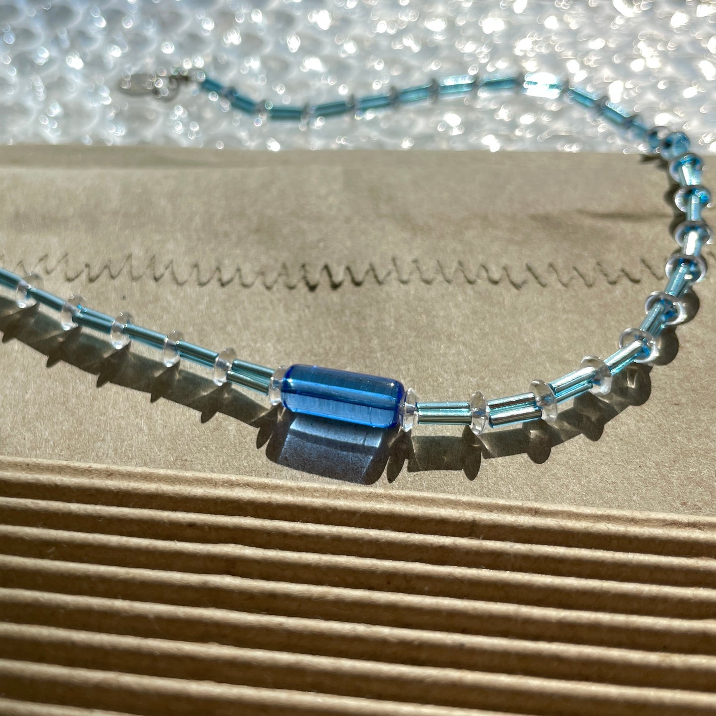 Detail of Bluejazz Necklace showing premium glass beads in deep blue and jewel tones with 925 sterling silver clasp, handmade in Cyprus.