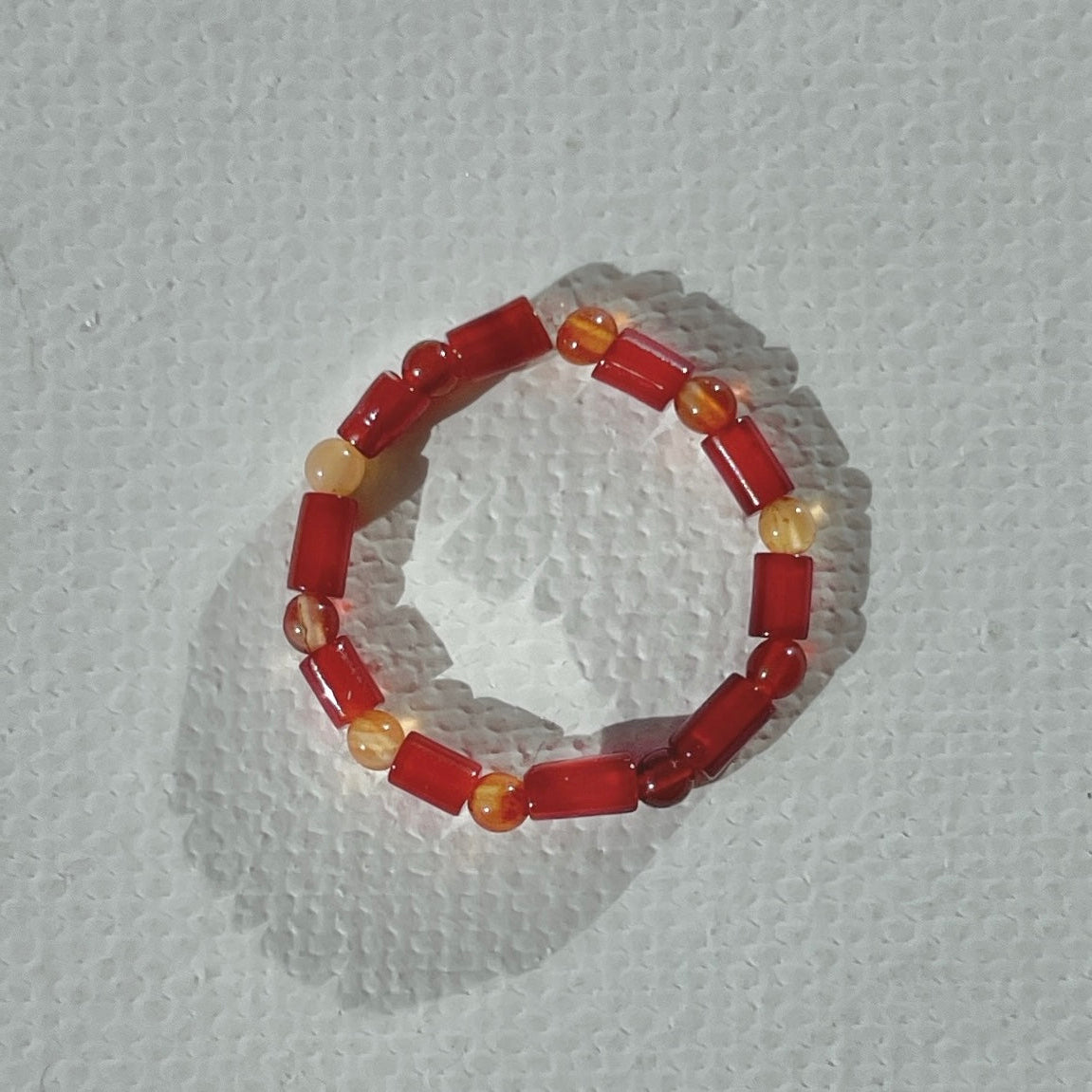 Handmade infinity ring with orange jade and cornelian gemstones on durable elastic cord, minimalist beaded jewelry by STRIPE+BEAT