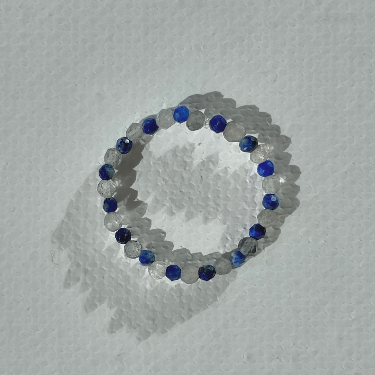 Handmade infinity ring with lapis lazuli and sparky labradorite gemstones on durable elastic cord, minimalist beaded jewelry by STRIPE+BEAT