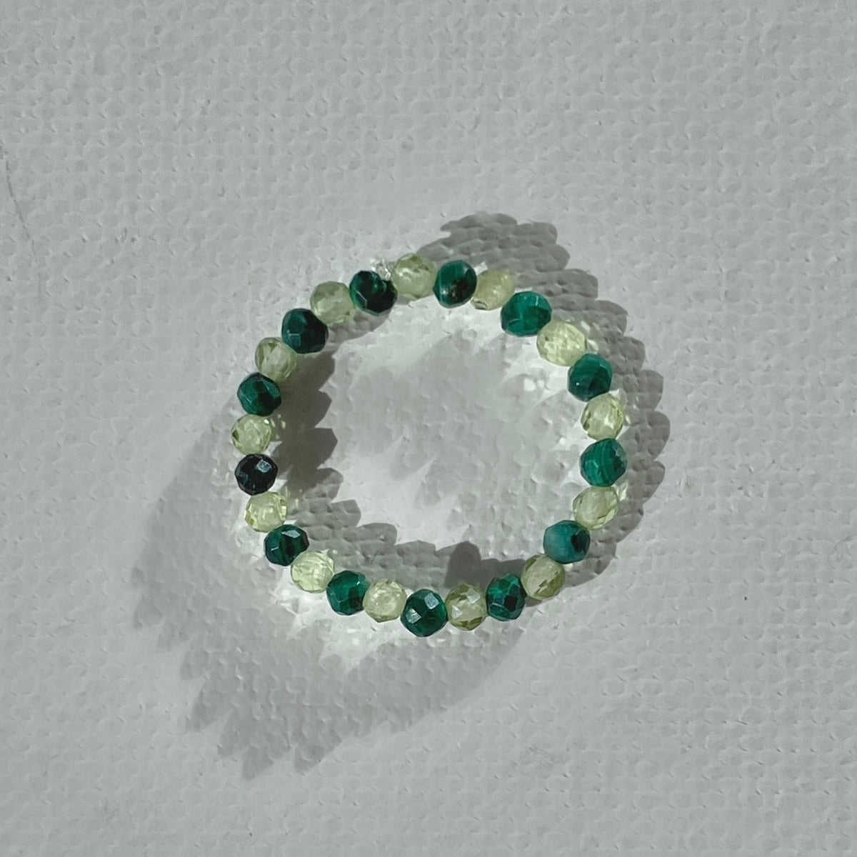 Handmade infinity ring with malachite and olive quartz gemstones on durable elastic cord, minimalist beaded jewelry by STRIPE+BEAT