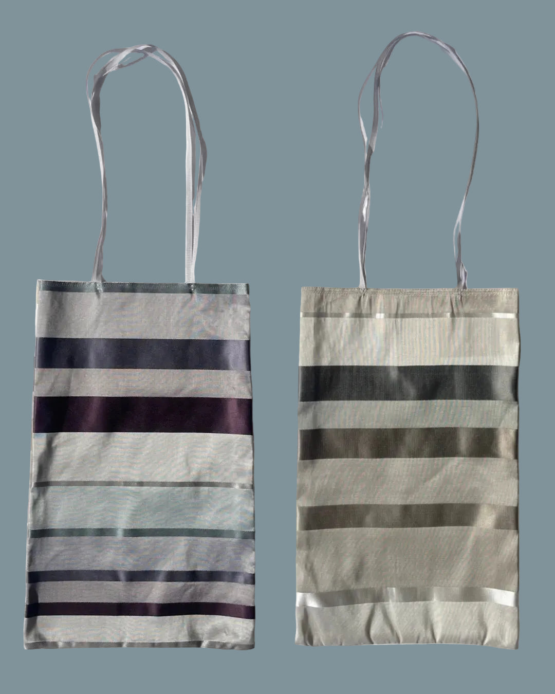 Silk fabric tote bag with horizontal striped patterns.