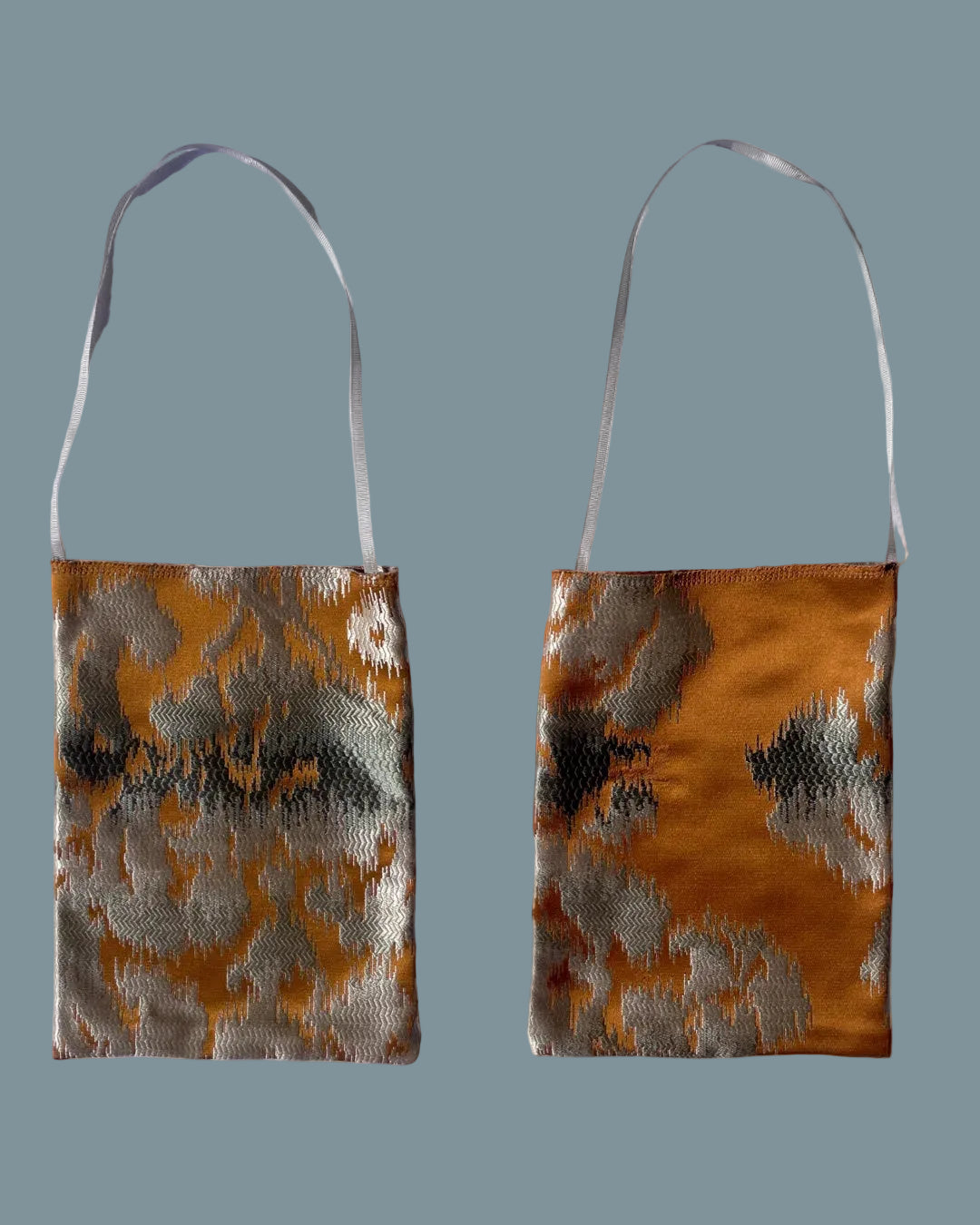 Two views of a small silk shoulder bag with a metallic golden brown and silver abstract pattern.