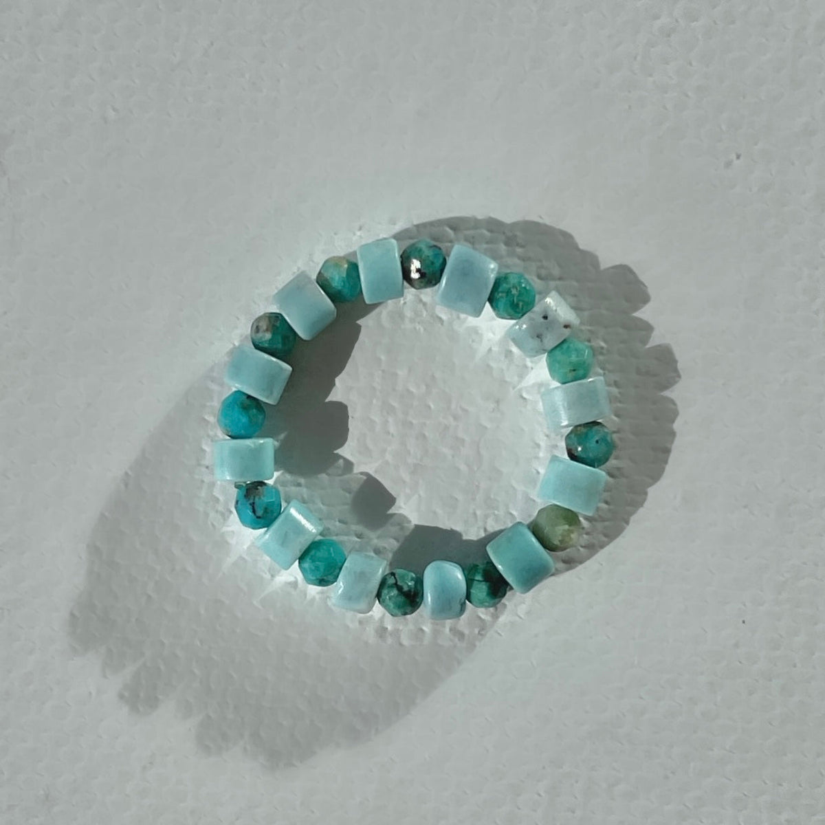 Handmade infinity ring with turquoise heishi and faceted gemstones on durable elastic cord, minimalist beaded jewelry by STRIPE+BEAT