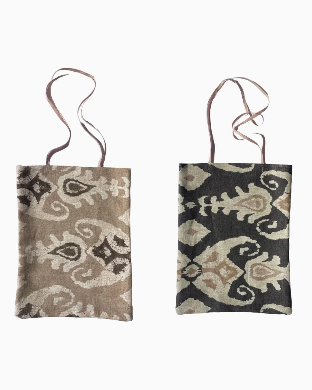 Woven linen tote bag with long handles. One side has a beige, brown, and cream ikat pattern, and the other - dark brown and beige ikat pattern.
