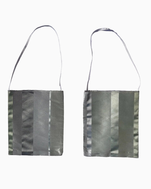 Two views of a small shoulder bag with a metallic silver-gray striped pattern and a thin dark strap.