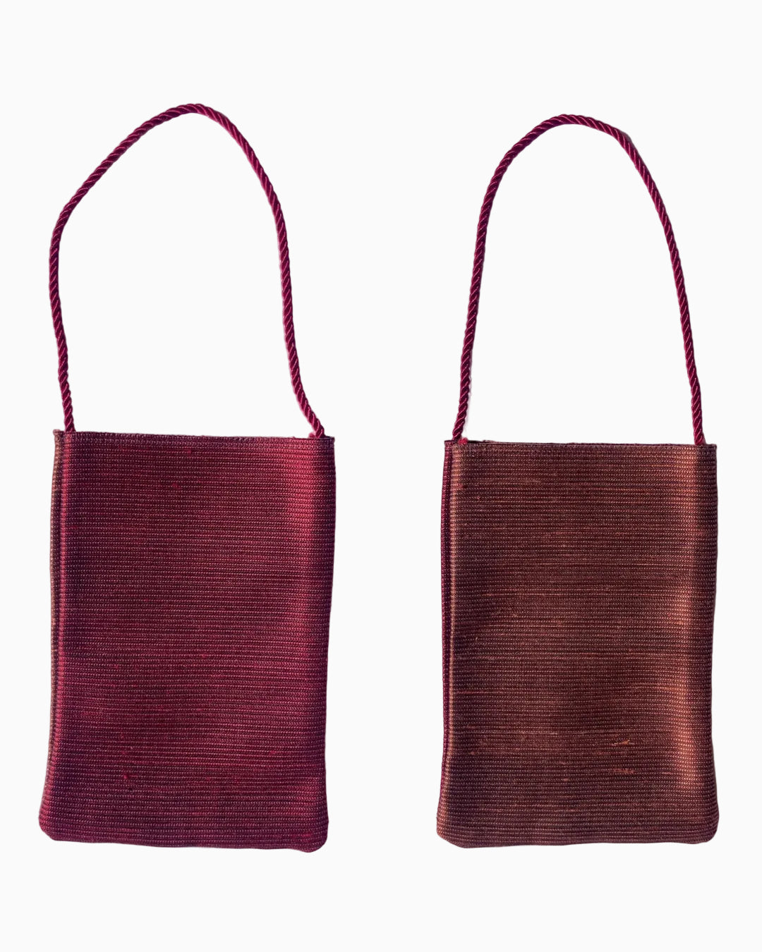 Small woven shoulder bag. One side is a deep burgundy red, and the other is a warm reddish-brown.