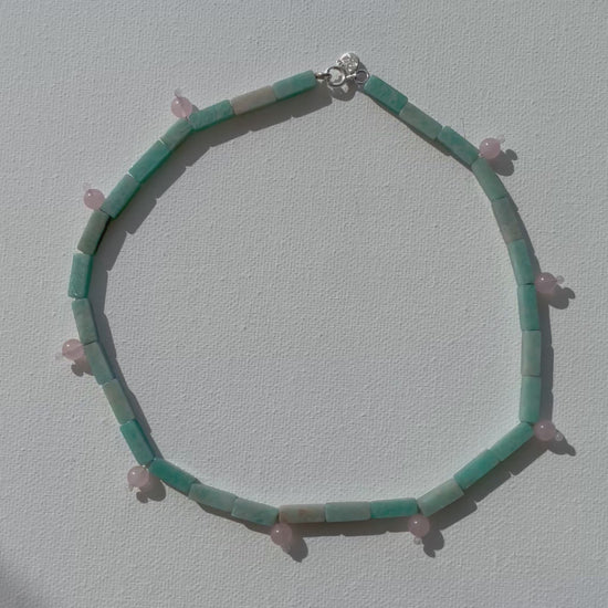 Close-up video of INFLOW necklace showing amazonite and rose quartz stones with silver details